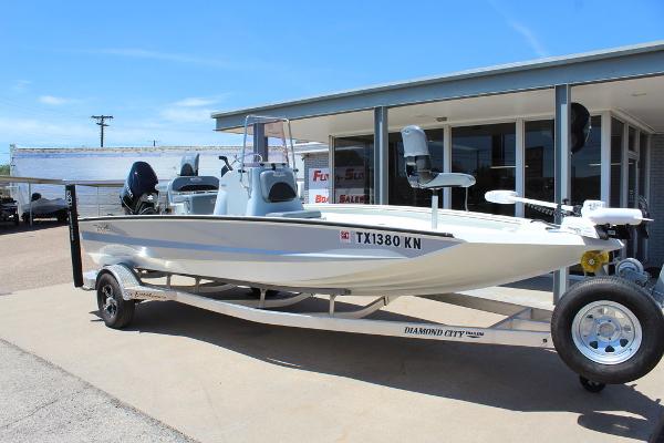 Slide: The Image of 2022 Excel Bay Pro 203 boat on trailer outside dealership. - 2