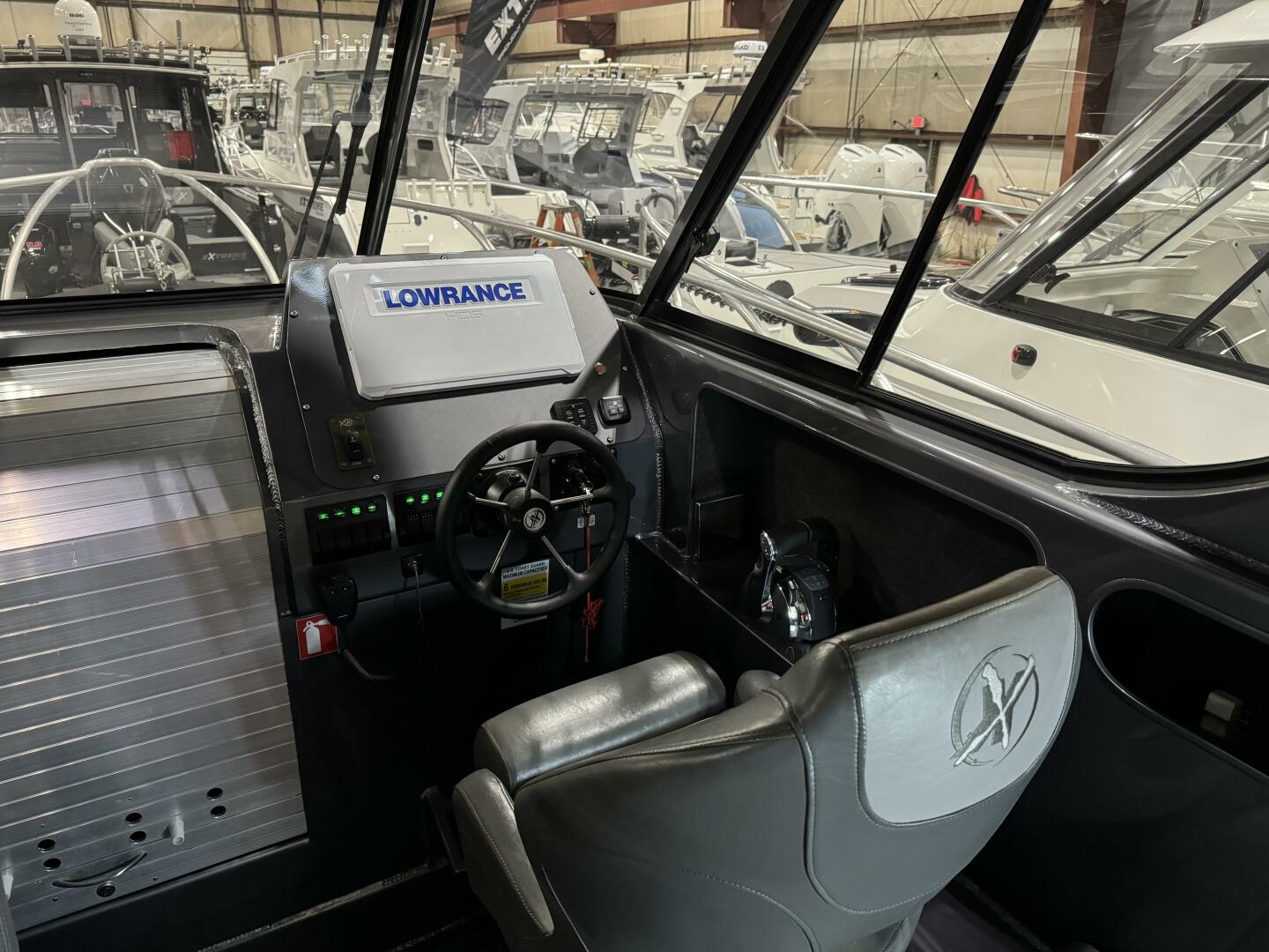 Slide: The Image of Helm  Captians seat with bolster, gps screen and steering wheel on this 2020 Extreme Boats 795 Walk Around - 5311272