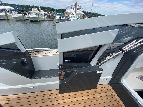 Slide: The Image of Fairline F//Line 33 yacht, 2022 model, docked with open door and wooden deck. - 11