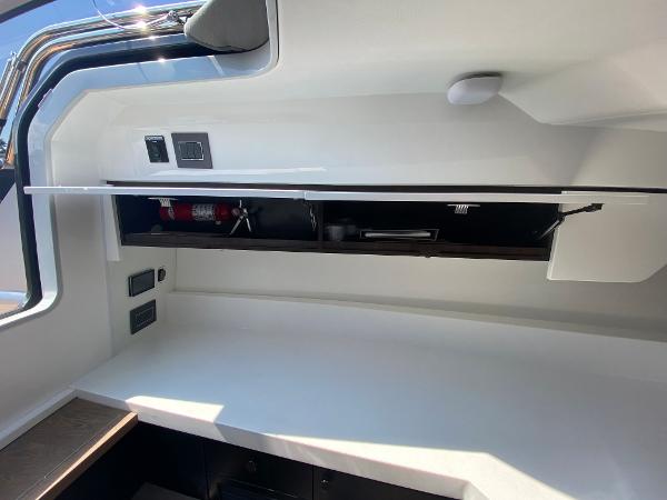 Slide: The Image of Interior view of 2022 Fairline F//Line 33 yacht with storage compartment open. - 12
