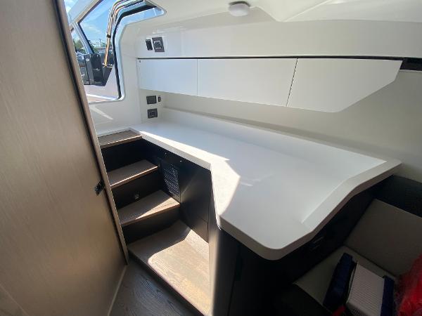 Slide: The Image of Interior of 2022 Fairline F//Line 33 yacht with modern white cabinetry and stairs. - 13
