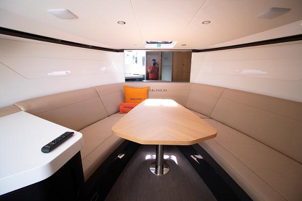 Slide: The Image of Interior of 2021 Fairline F Line 33 yacht with beige seating and wooden table. - 14