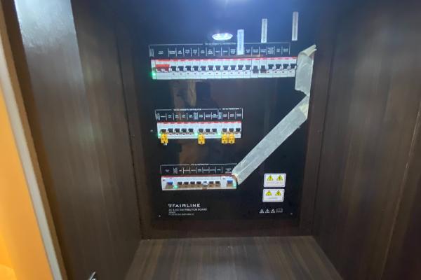 Slide: The Image of Electrical panel inside 2022 Fairline F//Line 33 yacht, featuring circuit breakers and warning labels. - 16