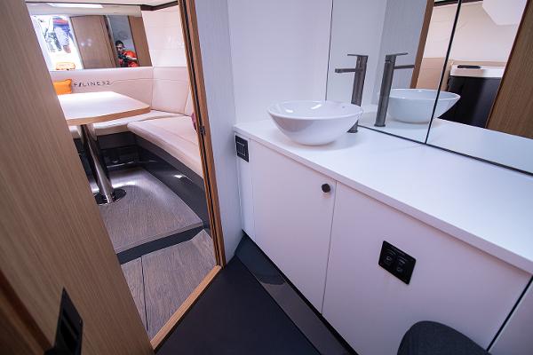 Slide: The Image of 2021 Fairline F Line 33 yacht interior with modern bathroom and seating area. - 19