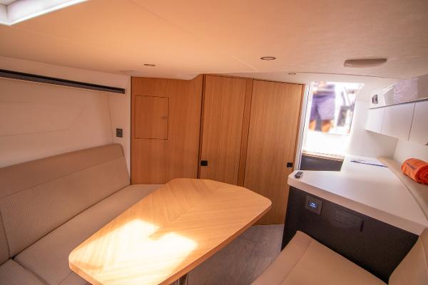 Slide: The Image of Interior of 2021 Fairline F Line 33 yacht with modern seating and wooden table. - 22