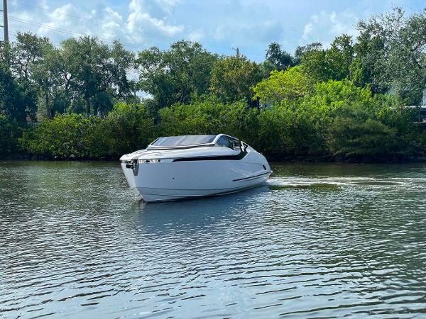 Slide: The Image of 2021 Fairline F Line 33 luxury yacht cruising on a serene river. - 3