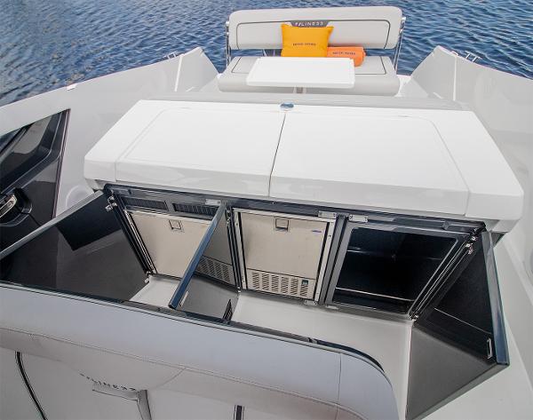 Slide: The Image of 2021 Fairline F Line 33 yacht with open storage compartments and seating area. - 36