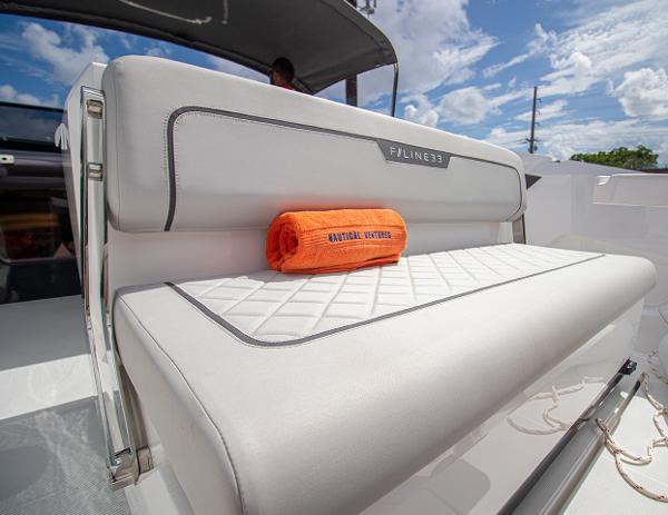 Slide: The Image of 2021 Fairline F Line 33 boat interior with white seating and orange towel. - 39