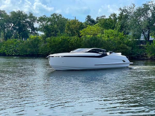 Slide: The Image of 2021 Fairline F Line 33 luxury yacht cruising on a serene river. - 4