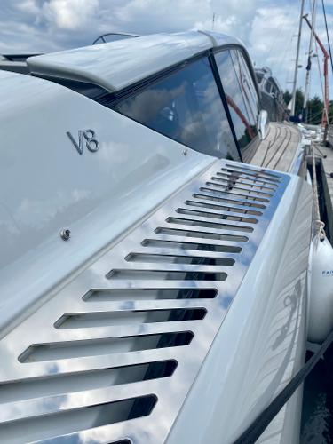 Slide: The Image of 2022 Fairline F//Line 33 yacht with V8 engine, sleek design, docked under cloudy sky. - 4