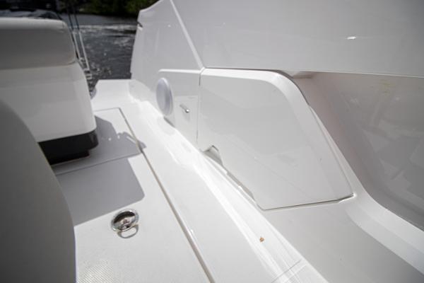 Slide: The Image of 2021 Fairline F Line 33 yacht deck detail with white seating and storage compartments. - 40