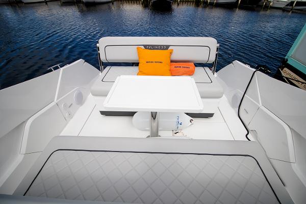Slide: The Image of 2021 Fairline F Line 33 yacht seating area with table and cushions. - 48