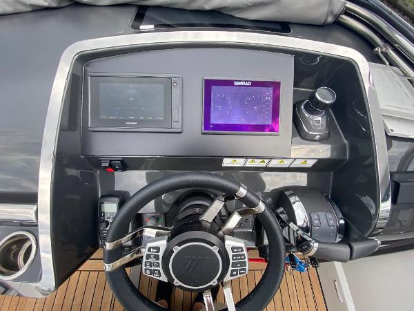 Slide: The Image of Helm of 2022 Fairline F//Line 33 yacht with modern navigation controls and displays. - 6