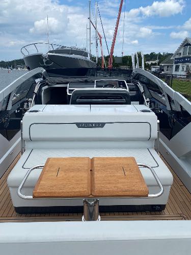 Slide: The Image of 2022 Fairline F//Line 33 luxury yacht with sleek design and wooden deck, docked at marina. - 7