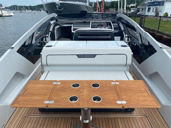 Slide: The Image of 2022 Fairline F//Line 33 yacht interior with wooden table and sleek design. - 8