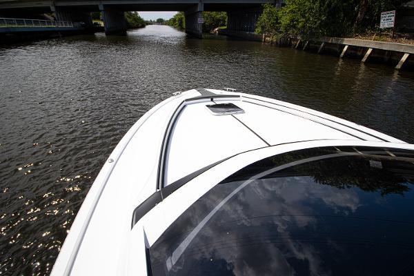 Slide: The Image of Fairline F Line 33 2021 yacht cruising on a river under a bridge. - 9