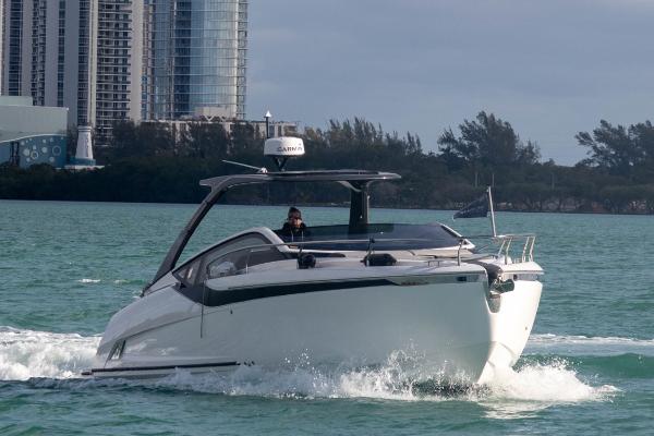 Slide: The Image of 2023 Fairline F//Line 33 Outboard cruising on water near cityscape. - 0