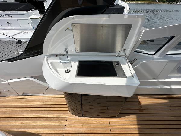 Slide: The Image of Fairline F//Line 33 Outboard 2023 yacht with open outdoor kitchenette on teak deck. - 13