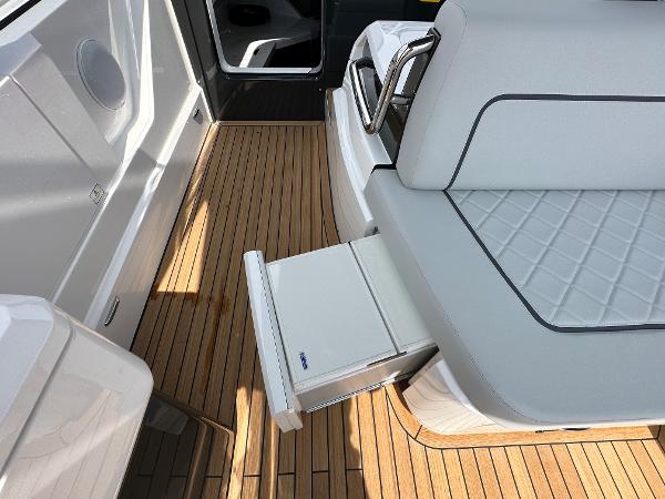 Slide: The Image of 2023 Fairline F//Line 33 Outboard interior with teak flooring and pull-out storage. - 17