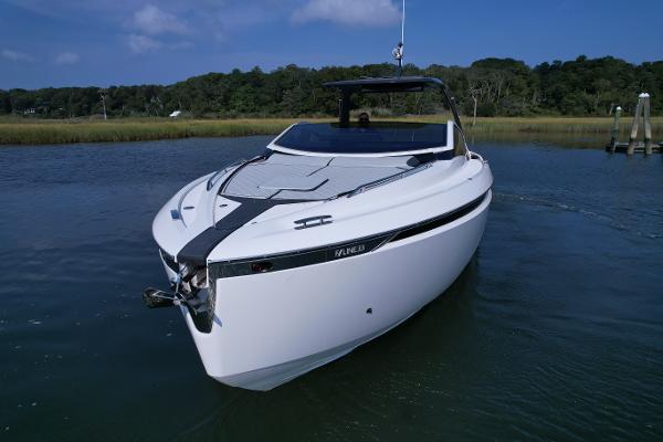 Slide: The Image of 2023 Fairline F//Line 33 Outboard luxury motor yacht on calm water. - 2