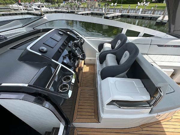 Slide: The Image of 2023 Fairline F//Line 33 Outboard cockpit with modern dashboard and comfortable seating. - 21