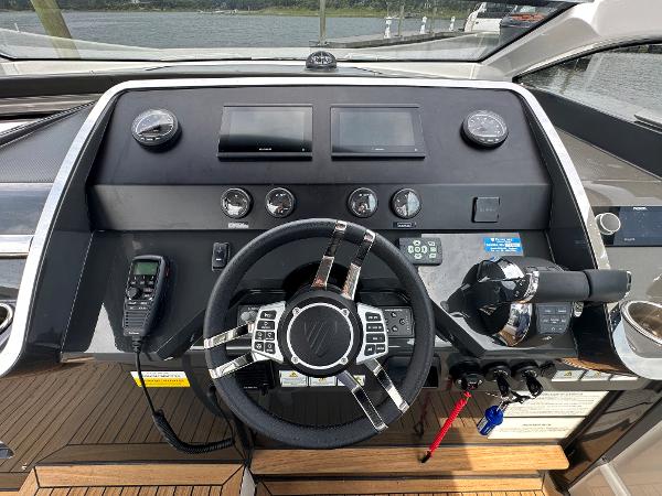 Slide: The Image of 2023 Fairline F//Line 33 Outboard helm with modern controls and navigation equipment. - 24