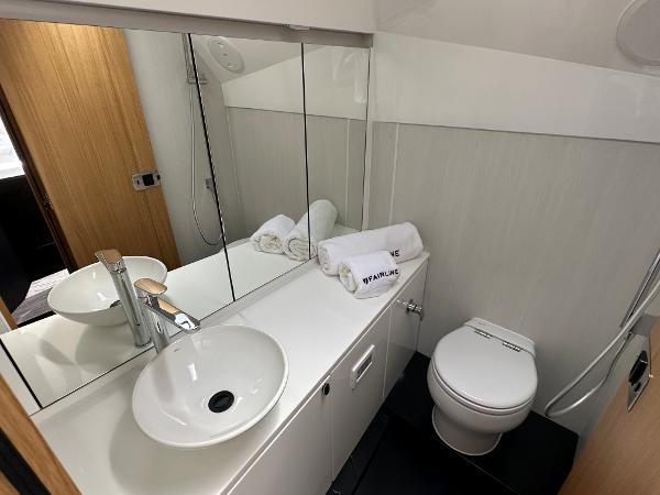 Slide: The Image of Modern bathroom in 2023 Fairline F//Line 33 Outboard yacht with sink, toilet, and mirror. - 25