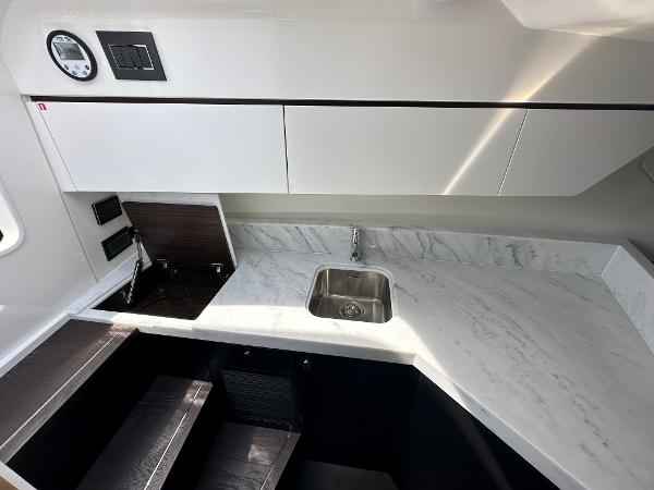 Slide: The Image of Modern kitchen area in 2023 Fairline F//Line 33 Outboard yacht with marble countertop. - 27