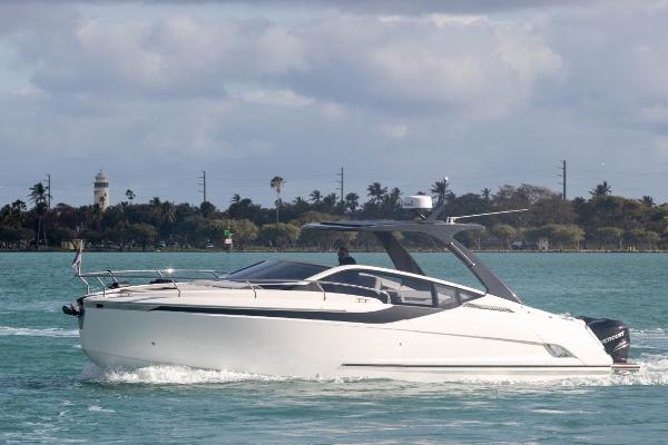 Slide: The Image of 2023 Fairline F//Line 33 Outboard cruising on water with scenic background. - 3