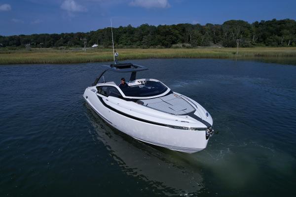 Slide: The Image of 2023 Fairline F//Line 33 Outboard luxury motor yacht cruising on a serene lake. - 3