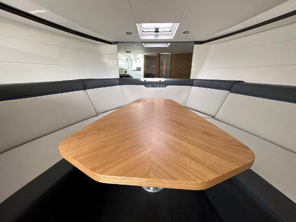 Slide: The Image of Interior of 2023 Fairline F//Line 33 Outboard yacht with modern seating and wooden table. - 30
