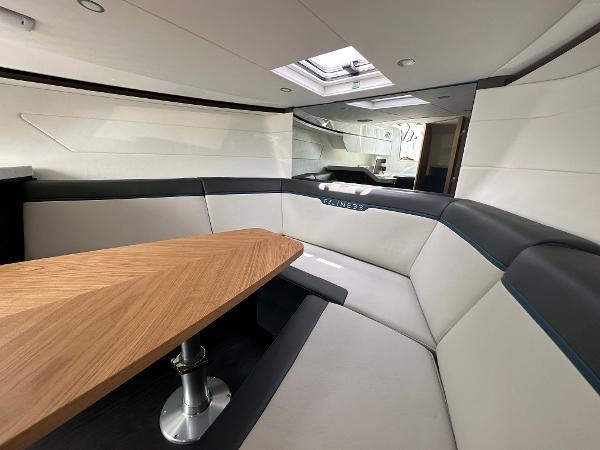 Slide: The Image of Interior of 2023 Fairline F//Line 33 Outboard yacht with modern seating and wooden table. - 31