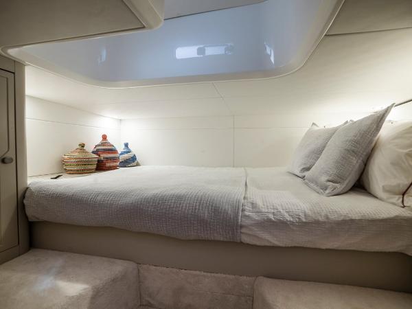 Slide: The Image of Interior cabin of 2023 Fairline F//Line 33 Outboard with cozy bed and decorative baskets. - 33