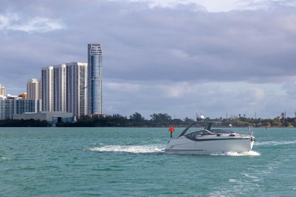 Slide: The Image of 2023 Fairline F//Line 33 Outboard cruising near city skyline. - 4