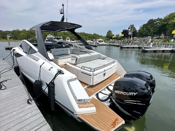 Slide: The Image of 2023 Fairline F//Line 33 Outboard luxury boat docked with twin Mercury engines. - 7