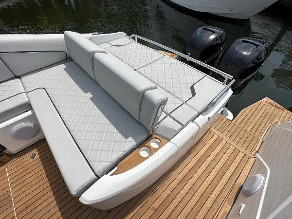 Slide: The Image of 2023 Fairline F//Line 33 Outboard luxury boat with cushioned seating and twin engines. - 9