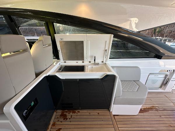 Slide: The Image of Fairline Targa 45 Open 2024 yacht interior with kitchenette and seating area. - 14