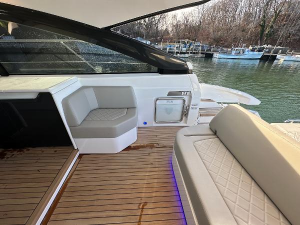 Slide: The Image of 2024 Fairline Targa 45 Open yacht with luxurious seating and waterfront view. - 16