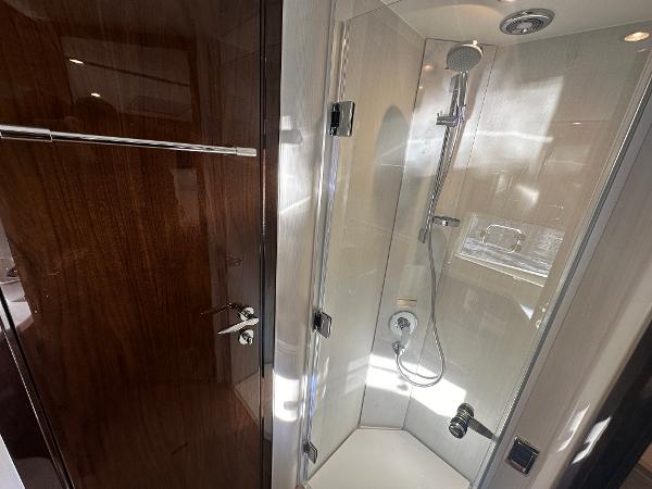 Slide: The Image of Fairline Targa 45 Open 2024 yacht bathroom with modern shower and wooden door. - 17