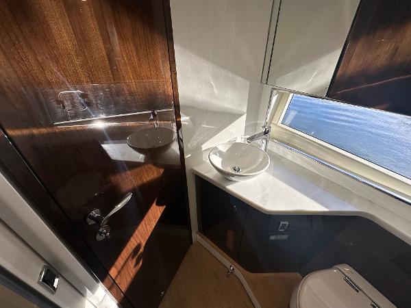 Slide: The Image of Fairline Targa 45 Open 2024 yacht bathroom with modern fixtures and wooden accents. - 18