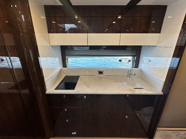 Slide: The Image of Modern kitchen in 2024 Fairline Targa 45 Open yacht with sleek cabinetry and ocean view. - 20