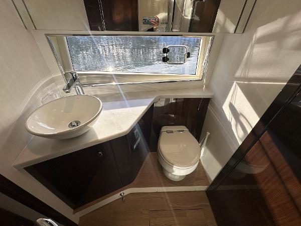Slide: The Image of Modern bathroom in 2024 Fairline Targa 45 Open yacht with sink, toilet, and window. - 26