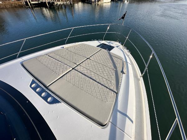 Slide: The Image of 2024 Fairline Targa 45 Open bow with sunpad, docked on calm water. - 30