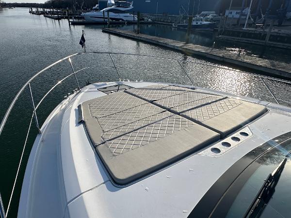Slide: The Image of 2024 Fairline Targa 45 Open yacht with sunbathing cushions on the bow, docked at a marina. - 32