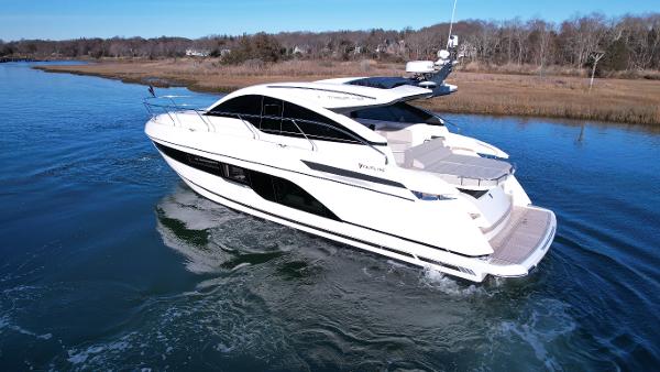 Slide: The Image of 2024 Fairline Targa 45 Open luxury yacht cruising on a serene waterway. - 5
