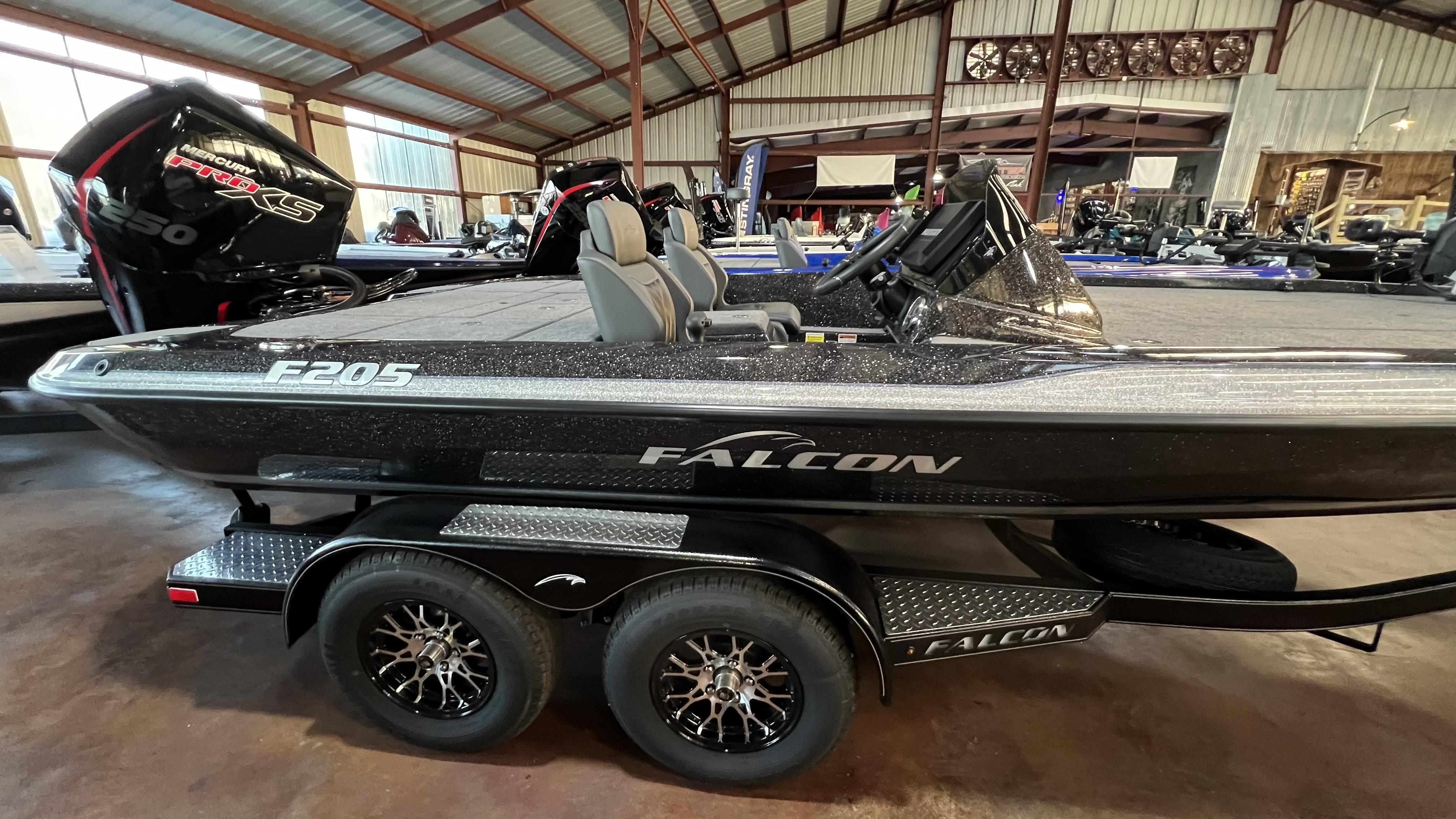 Slide: The Image of 2024 Falcon F205 boat with Mercury Pro XS engine in showroom. - 1