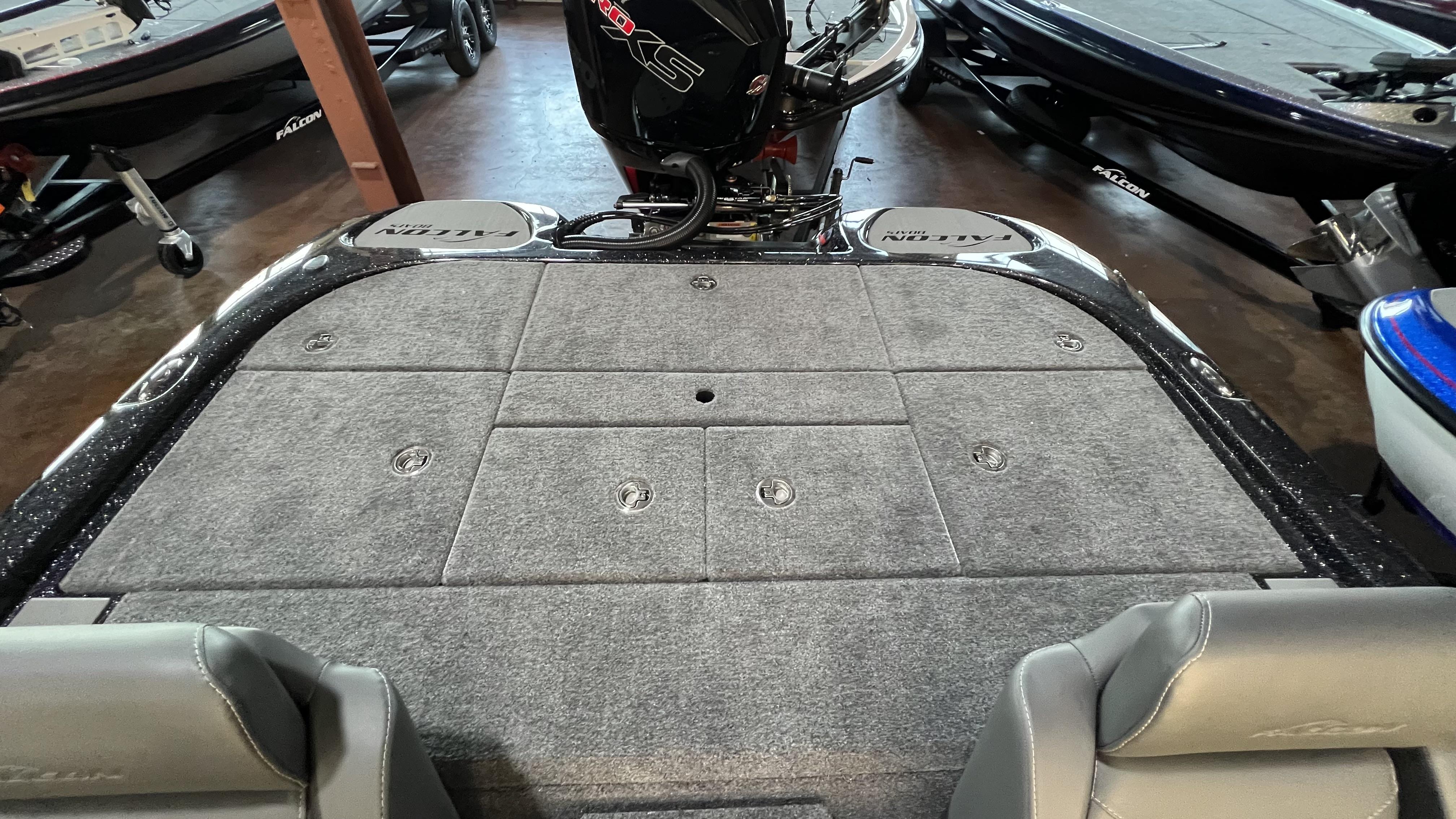 Slide: The Image of 2024 Falcon F205 boat interior with carpeted deck and storage compartments. - 24