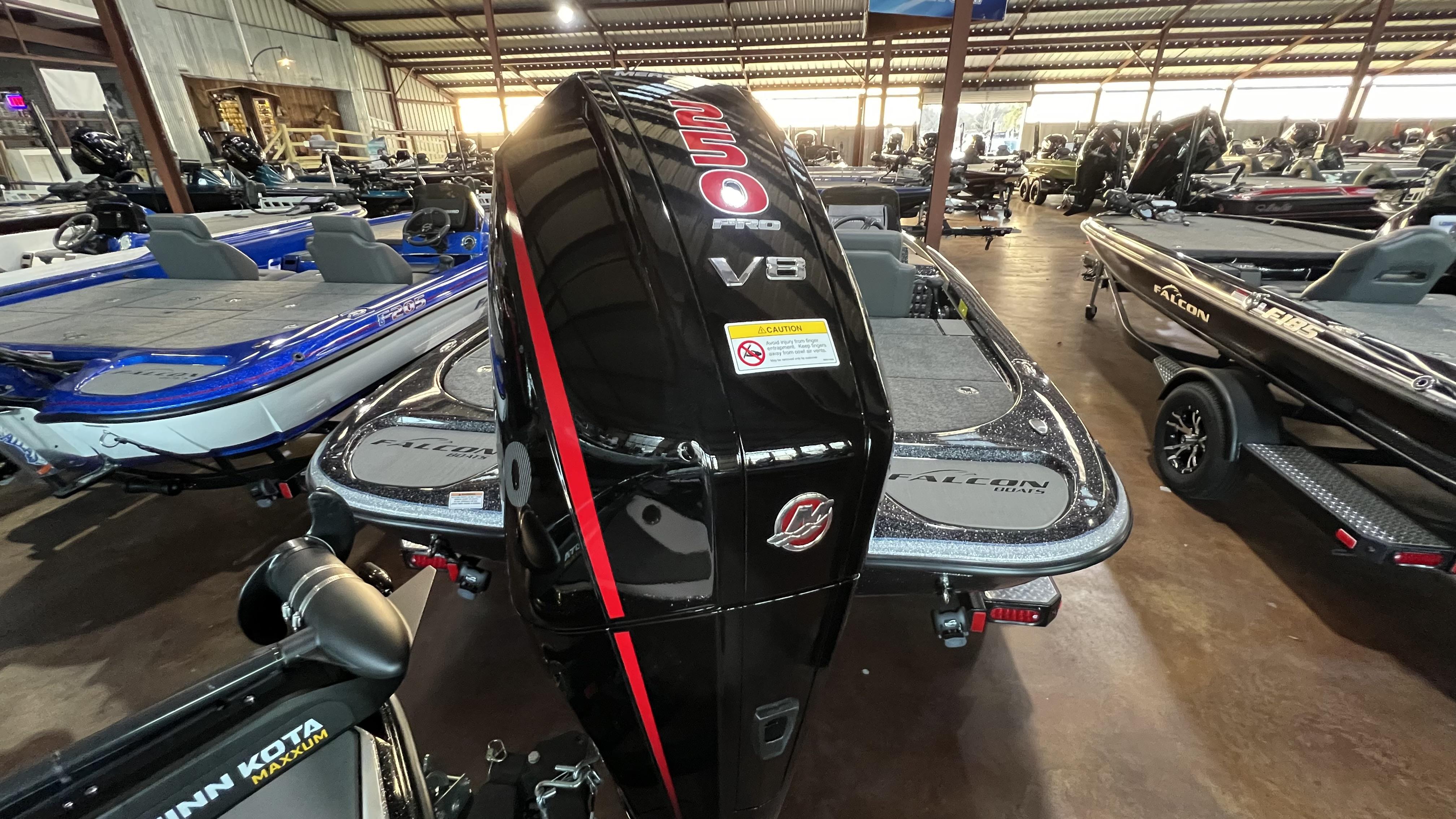 Slide: The Image of 2024 Falcon F205 boat with a powerful V8 engine in a showroom. - 25