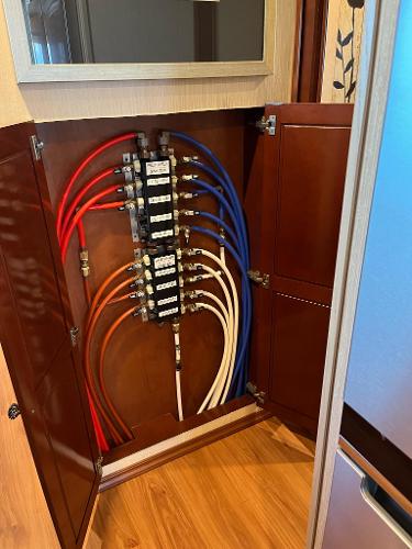 Slide: The Image of Houseboat plumbing system with color-coded pipes inside a wooden cabinet, Fantasy model, 2009. - 15