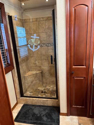 Slide: The Image of 2009 Fantasy Houseboat bathroom with tiled shower and glass door. - 19